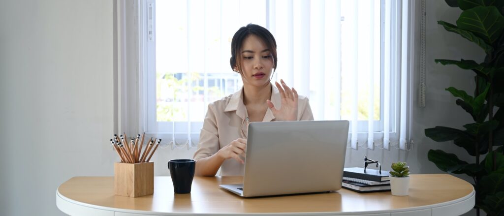 young businesswoman using laptop computer virtual video conference with her business partner